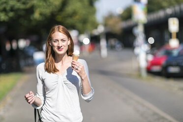 Portrait of smiling woman eating icecream - TAMF00798
