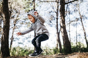 Little boy jumping in the air in the woods - JRFF01049