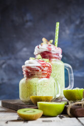 Gläser mit Kiwi-Limetten-Smoothie mit Kokosnusscreme und Himbeersauce - SBDF03067