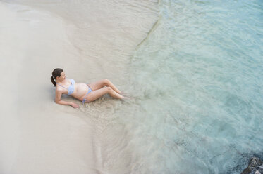 Pregnant woman sitting at the sea - DIGF01430