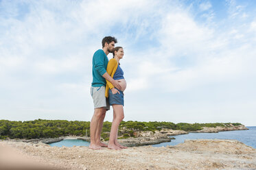 Expectant parents standing at the sea - DIGF01450
