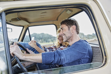 Smiling couple in pick up truck - FMKF03197