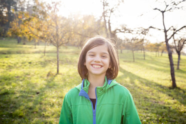 Portrait of smiling girl on a meadow in autumn - LVF05597
