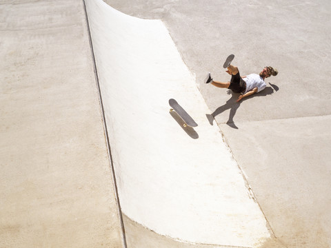 Young man skate boarding in skate park stock photo