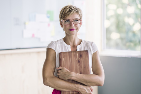 Businesswoman holding laptop stock photo