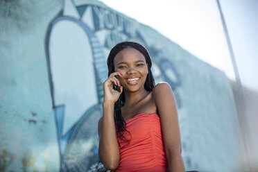 Smiling woman talking on cell phone - ZEF11650