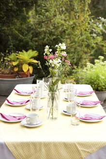 Gedeckter Tisch im Garten, dekoriert für eine Geburtstagsfeier - MFRF00726