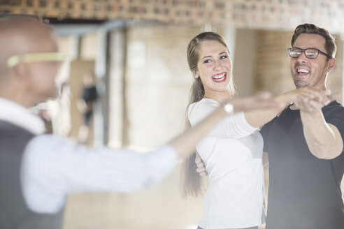 Smiling dance partners together in dance class with instructor - ZEF11721