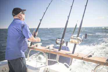 Man on boat deep sea fishing - ZEF11759