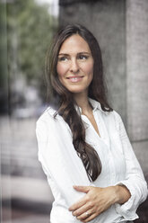 Portrait of confident businesswoman looking out of window - PESF00371