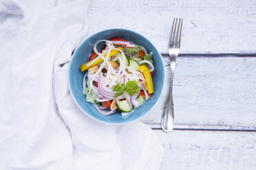Bowl of glass noodle salad with vegetables, cloth and fork on wood - LVF05611