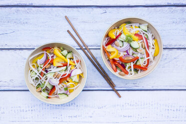 Two bowls of glass noodle salad with vegetables on wood - LVF05616