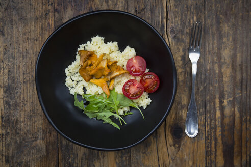 Schale mit Couscous-Salat mit Tomaten, Rucola und Pfifferlingen auf Holz - LVF05626