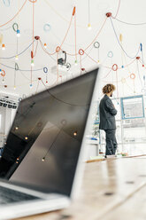 Young businessman standing at window - JOSF00399