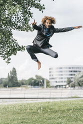 Junger Geschäftsmann springt auf Slackline - JOSF00426