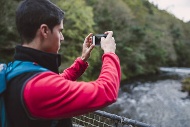 Hiker taking a photo in nature - RAEF01559