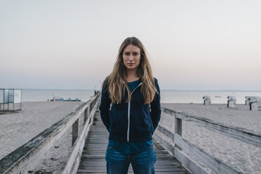 Portrait of young woman standing on jetty - KNSF00708