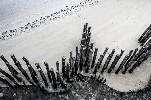 Frankreich, Lancieux Blick auf Holzpfähle am Strand von oben - FMKF03258