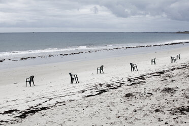 France, Lancieux, sandy beach with row of chairs - FMKF03262