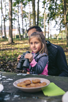 Little girl with binocular relaxing with her father in a forest - DAPF00494