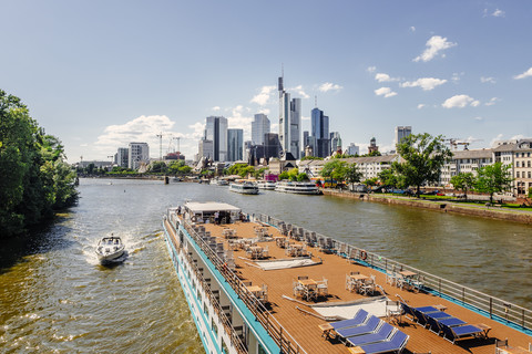 Germany, Frankfurt, view to skyline with tour boat on Main River in the foreground stock photo