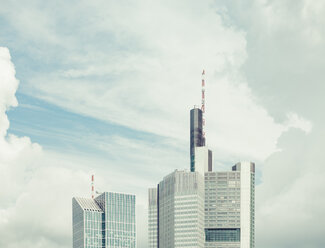 Germany, Frankfurt, upper parts of two skyscrapers in front of dramatic clouds - KRPF02041