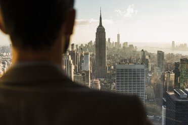 USA, New York City, man looking on cityscape on Rockefeller Center observation deck - UU09352