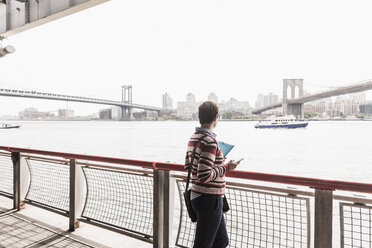 USA, New York City, woman at East River - UUF09427