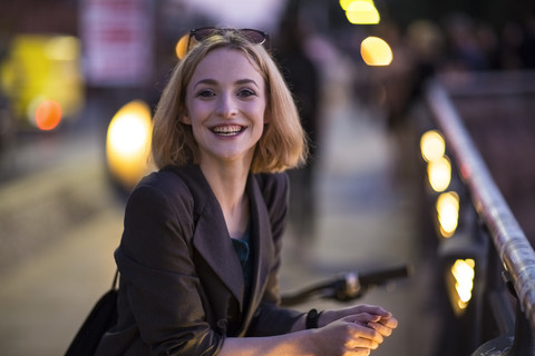 Portrait of happy young woman in the evening stock photo