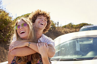 Carefree couple hugging outdoors in summer - WESTF21984