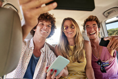 Glückliche Freunde in einem Auto, die ein Selfie machen - WESTF22002