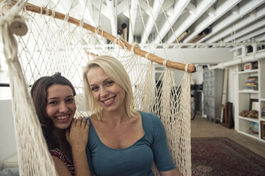 Portrait of two smiling young women in hammock - WESTF22111