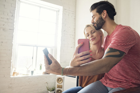 Happy young couple taking a selfie stock photo