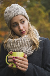 Junge Frau mit Heißgetränk im Herbst - KKAF00080