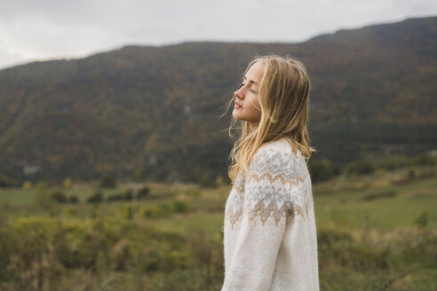 Young woman wearing pullover outdoors - KKAF00082