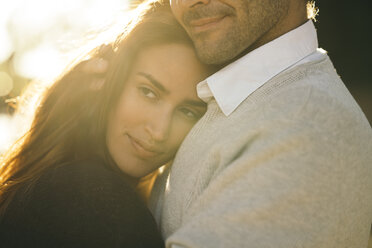 Portrait of happy woman with head on her husbands shoulder - KKAF00127