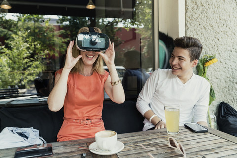 Teenage boy and woman wearing VR glasses stock photo