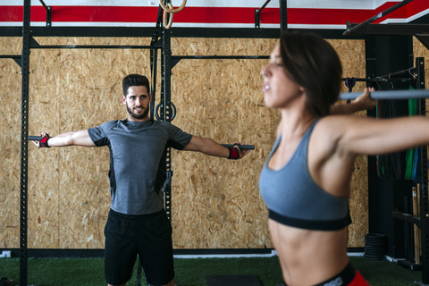 Mann und Frau trainieren im Fitnessstudio, lizenzfreies Stockfoto