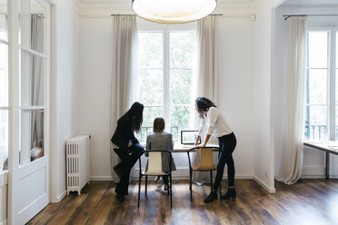 Three businesswomen in office working together on computer - EBSF01881