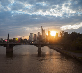 Germany, Frankfurt, view to financial district at sunset with Ignatz-Bubis-Bridge in the foreground - KRPF02058