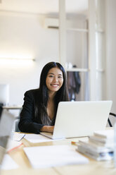 Young Asian woman working in office using laptop - EBSF01911