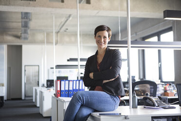 Portrait of smiling businesswoman in office - RBF05244