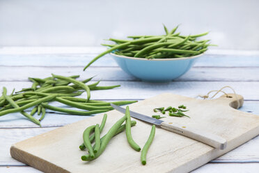 Green beans, wooden board and kitchen knife on wood - LVF05646