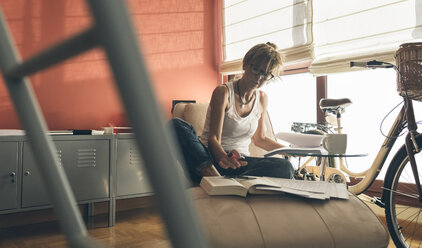 Woman at home working on script - MGOF02665