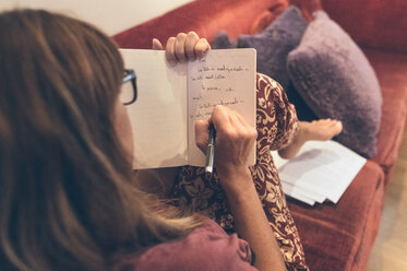 Woman writing in notebook - MGOF02680