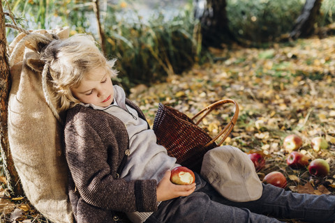 Hansel and Gretel, Boy in forest leaning against tree, sleeping stock photo