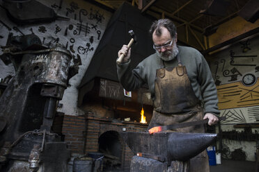 Blacksmith at work in his workshop - ABZF01576