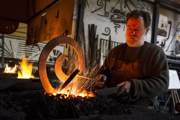 Blacksmith at work in his workshop - ABZF01581