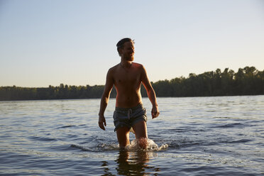 Happy young man in a lake - FMKF03297