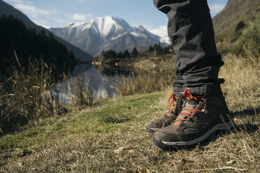 France, Pyrenees, Pic Carlit, close-up of hiker taking a rest at mountain lake - KKAF00161
